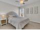 Neutral bedroom featuring a tufted headboard, bedside table and decorative art at 5073 Blair Rd, Summerville, SC 29483