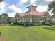 A white gazebo-style community amenity with a red roof surrounded by greenery at 5073 Blair Rd, Summerville, SC 29483