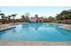Large community pool with marked depths, featuring a white and red pool house with a red roof at 5073 Blair Rd, Summerville, SC 29483