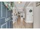 Bright entryway with wood flooring, decorated door, and view to an open floor plan at 5073 Blair Rd, Summerville, SC 29483
