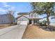 Charming two-story home with gray siding, a two-car garage, and a welcoming front porch at 5073 Blair Rd, Summerville, SC 29483