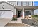 Inviting front porch with gray siding, brick accents, and comfortable seating at 5073 Blair Rd, Summerville, SC 29483