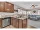 Kitchen sink with stainless steel dishwasher overlooks the living room, creating an open-concept feel at 5073 Blair Rd, Summerville, SC 29483