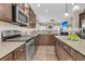 A kitchen boasts wood cabinets, a microwave, and a center island, blending functionality with style at 5073 Blair Rd, Summerville, SC 29483