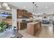 A modern kitchen with wood cabinets, an island, stainless steel appliances, and an outdoor view at 5073 Blair Rd, Summerville, SC 29483