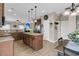 A spacious kitchen with wood cabinets, a center island, stainless steel appliances, and a dining area at 5073 Blair Rd, Summerville, SC 29483