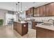 Kitchen boasts stainless steel appliances, wood cabinets, a central island, and adjacent dining area at 5073 Blair Rd, Summerville, SC 29483