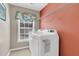 Laundry room featuring a front load washer and dryer and wire shelf at 5073 Blair Rd, Summerville, SC 29483