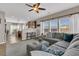 Open living room boasts a large gray sectional, fan, and windows for ample natural light at 5073 Blair Rd, Summerville, SC 29483