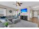 Cozy living room featuring a plush sectional sofa, large windows, and stylish decor at 5073 Blair Rd, Summerville, SC 29483