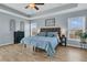 Comfortable main bedroom featuring tray ceilings, hardwood floors, and plentiful natural light at 5073 Blair Rd, Summerville, SC 29483