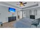 Relaxing main bedroom features a TV, tray ceiling, and ensuite bathroom entrance at 5073 Blair Rd, Summerville, SC 29483