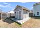 A backyard storage shed with a small porch and neutral paint at 5073 Blair Rd, Summerville, SC 29483