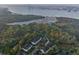 Aerial view shows property adjacent to marshlands, with nearby residences and a harbor backdrop at 509 Seven Farms Dr, Charleston, SC 29492