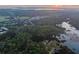 Aerial view shows property bordering the marshlands, outlined in white, with sunset views at 509 Seven Farms Dr, Charleston, SC 29492