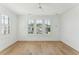 Bright, empty bedroom featuring hardwood flooring, a ceiling fan, and windows with shutter blinds at 509 Seven Farms Dr, Charleston, SC 29492