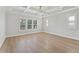 Bright bedroom with tray ceiling, ceiling fan, and large windows at 509 Seven Farms Dr, Charleston, SC 29492