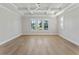 Bright bedroom with tray ceiling, ceiling fan, and large windows at 509 Seven Farms Dr, Charleston, SC 29492