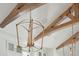 Close-up of chandelier with wooden ceiling beams at 509 Seven Farms Dr, Charleston, SC 29492