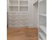 Custom closet with built-in shelving, drawers, and gold hardware, offering ample space at 509 Seven Farms Dr, Charleston, SC 29492