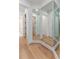 Hallway featuring hardwood flooring, large mirrors, and white trim leading to various rooms at 509 Seven Farms Dr, Charleston, SC 29492