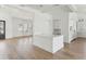 Open floor plan showcasing the kitchen island with a sink and the seamless flow to the living area at 509 Seven Farms Dr, Charleston, SC 29492