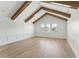 Bright living room with vaulted ceilings, wood beams, hardwood floors, and wainscotting at 509 Seven Farms Dr, Charleston, SC 29492