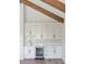 Wet bar featuring white cabinets, marble backsplash, a wine fridge, and sleek hardware at 509 Seven Farms Dr, Charleston, SC 29492