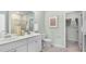 Bright bathroom featuring a dual sink vanity, framed art and a walk in closet at 542 Richfield Way, Summerville, SC 29486