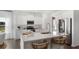 Modern white kitchen featuring stainless steel appliances, a center island with seating, and bright natural light at 542 Richfield Way, Summerville, SC 29486