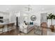 Bright open-concept living space with hardwood floors, modern decor, and a view into the kitchen at 542 Richfield Way, Summerville, SC 29486
