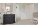 Charming Bedroom featuring striped wallpaper, a dark dresser, and a cozy crib at 548 Richfield Way, Summerville, SC 29486