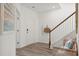 Welcoming entryway with a cozy bench, wood railing staircase, and an inviting front door at 548 Richfield Way, Summerville, SC 29486