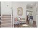 Elegant hallway featuring a decorative mirror, a stylish bench, and hardwood floors leading to the living area at 548 Richfield Way, Summerville, SC 29486