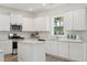 Well-lit kitchen with sleek white cabinets, stainless steel appliances, granite countertops, and a practical island at 548 Richfield Way, Summerville, SC 29486