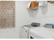 Bright laundry room featuring modern, white, front load washer and dryer set and decorative wall art at 548 Richfield Way, Summerville, SC 29486