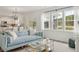 Inviting living room with a comfortable blue sofa, stylish decor, and a view of the adjacent kitchen and dining area at 548 Richfield Way, Summerville, SC 29486