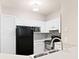 Updated kitchen featuring white cabinets, granite countertops, stainless appliances, and a modern backsplash at 60 Fenwick Hall Allee # 521, Johns Island, SC 29455
