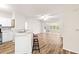 Open kitchen with updated appliances, white cabinets, bar top area, and hardwood floors at 60 Fenwick Hall Allee # 521, Johns Island, SC 29455