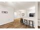 Bright living room featuring wood floors and open access to the kitchen with bar seating at 60 Fenwick Hall Allee # 521, Johns Island, SC 29455