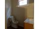 Bathroom featuring a toilet, wood vanity, and a large window providing natural light at 668 Rutledge Ave, Charleston, SC 29403