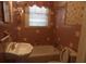 Retro bathroom featuring pink tiles, pedestal sink, bathtub, and seashell wallpaper at 668 Rutledge Ave, Charleston, SC 29403