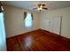 Cozy bedroom featuring hardwood floors, a window with curtains, and a ceiling fan with light fixture at 668 Rutledge Ave, Charleston, SC 29403
