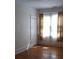 Bright bedroom features hardwood floors, a window with curtains, and a closet at 668 Rutledge Ave, Charleston, SC 29403