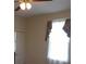 Bedroom featuring a ceiling fan, window with curtains, and a white door at 668 Rutledge Ave, Charleston, SC 29403