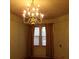 Dining area with a gold chandelier, hardwood floors, and natural light from window at 668 Rutledge Ave, Charleston, SC 29403