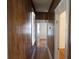 Hallway featuring wood paneling, window with blinds, and doors leading to other rooms at 668 Rutledge Ave, Charleston, SC 29403