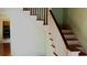 Traditional staircase with white railings and natural wood steps, leading to the upper level at 668 Rutledge Ave, Charleston, SC 29403