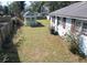 Spacious backyard with a small green outbuilding and partial fencing at 727 Spark St, Mount Pleasant, SC 29464