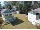 Spacious backyard with a small green outbuilding and partial fencing at 727 Spark St, Mount Pleasant, SC 29464